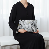 V2 — Seated, Djellaba Noir, Valina Beige Noir on lap