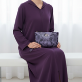 V2 — Seated, Djellaba Violet, clutch on lap