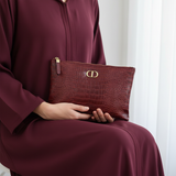 Valina Cuir Rouge seated close-up clutch lap detail