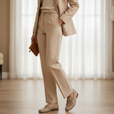 Woman in beige camel tailored suit with soft daylight wearing 447f Candy Beige loafers