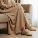 Woman in beige taupe matte djellaba sitting gracefully with soft daylight wearing 447f Candy Beige loafers