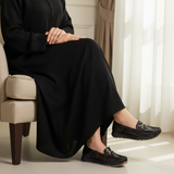 Woman in black djellaba wearing 542F Moksa moccasins - variation 1
