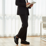 Woman in black formal suit standing wearing 224F Balem slip-ons