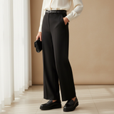 Woman in black trousers and ivory blouse with soft daylight wearing 306F Nexa Noir loafers