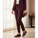 Woman in burgundy plum tailored suit with soft daylight wearing 447f Candy Grenat loafers