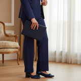 Woman in navy formal suit standing wearing 570F Nawar ballerinas
