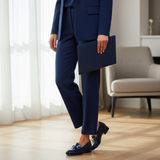 Woman in navy formal suit standing wearing 738F Senflo loafers