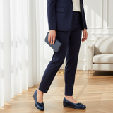 Woman in navy tailored suit in modern interior wearing 196F Labelle Bleu Marine
